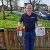 Neville Harris with two life saving defibrillators.