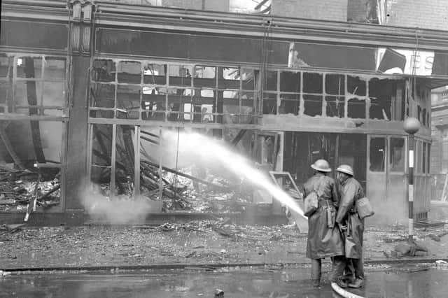 Firemen damping down the wreckage from the incendiary bombs which hit Binns on this day in 1941.