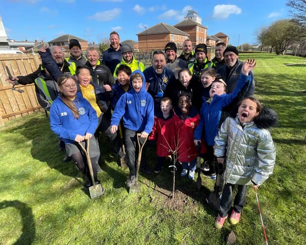 Bernicia estates team and 0800 Repair team with Dame Dorothy School children planting fruit trees in their secret garden. Submitted.