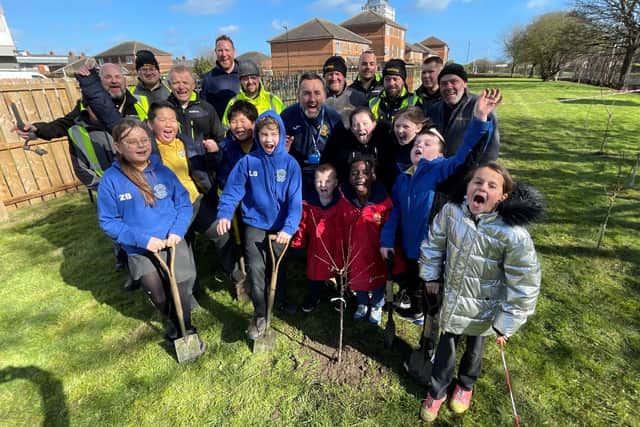 Bernicia estates team and 0800 Repair team with Dame Dorothy School children planting fruit trees in their secret garden. Submitted.