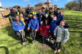 Bernicia estates team and 0800 Repair team with Dame Dorothy School children planting fruit trees in their secret garden. Submitted.
