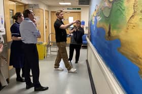 Neil Gibbins shows STSFT Chief Executive Ken Bremner MBE, Ward Manager Sam Charmichael and Matron Carol Gibson his mural on Ward E56. Submitted picture.