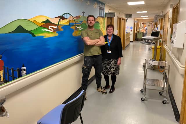 Neil Gibbins with STSFT Executive Director of Nursing, Midwifery and Allied Health Professionals Melanie Johnson with his artwork on Ward E56. Submitted picture.