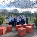 Children at North View Academy give a thumbs up to their new forest school and garden.