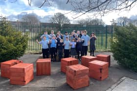 Children at North View Academy give a thumbs up to their new forest school and garden.