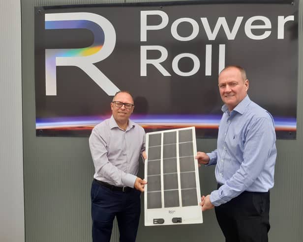 Neil Spann (left) and Ross Nagle with an example of the Power Roll solar panels.