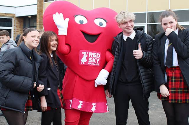 Pupils give a thumbs up to the Red Sky Foundation.