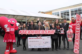 Southmoor Academy pupils handing over a cheque to the Red Sky Foundation's founder, Sergio Petrucci.