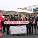 Southmoor Academy pupils handing over a cheque to the Red Sky Foundation's founder, Sergio Petrucci.