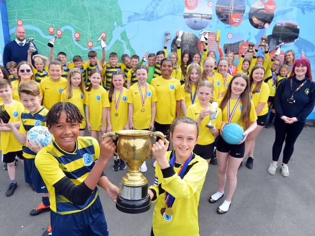 Children and staff at Fulwell Junior School celebrate their sporting success.