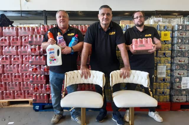 Manager Dean Martins and co-owners Lee Taylor and Dean Kelly with some of the bargain products on offer.
