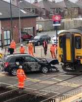 Network Rail staff work to remove an SUV from the track after it was hit by a train on a crossing at Redcar Central, Middlesbrough, on Wednesday May 1 2024. 