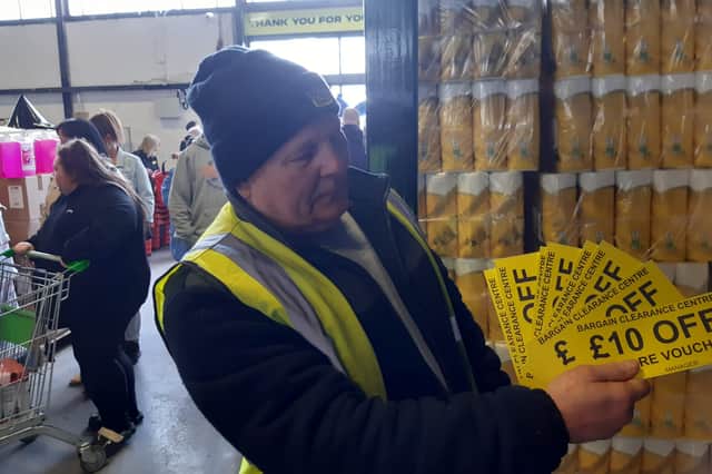 First customer Eddie English with his £100 worth of store vouchers.