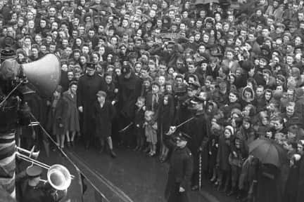 A band plays as the crowd waits to hear the official news - that war was over in Europe.