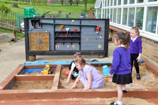 Children enjoy playing in the new sandpit.