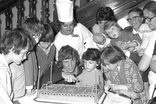 Jimmy chats to the children after taking his testimonial cake to them in 1974.
