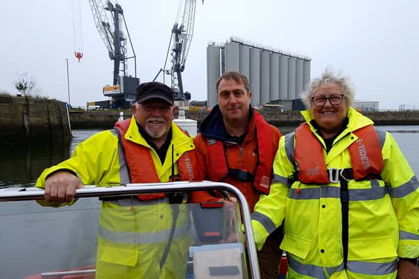 Reporter Neil Fatkin with patrol vessel crew members Peter Johnson and Alison Pake.
