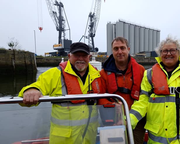 Reporter Neil Fatkin with patrol vessel crew members Peter Johnson and Alison Pake.
