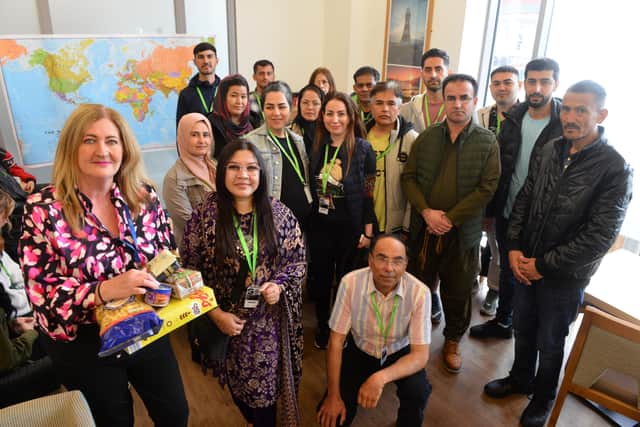 EPNE strategic lead for community engagement Jane Reed handing over some of the food items to local refugees and seekers of sanctuary.