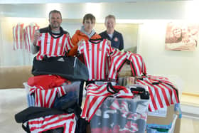 (Left to right) Deputy headteacher Richard Burroughs, student Noah Fairweather, and head of education at SAFC Don Peattie with the boxes of kit being donated to children living in poverty in Kenya. 