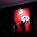 Protesters pasting over the royal portrait (Photo: Animal Rising/Supplied)