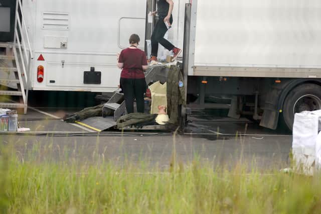 Crew members with what appear to be costumes for the production