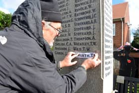 Stone carver and letter cutter David Edwick adding the extra names to the South Hylton War Memorial