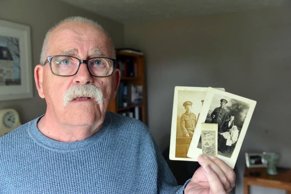 Colin John Clark with photographs of his great-great uncles, Charles and William Rathbone.