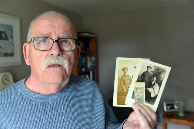 Colin John Clark with photographs of his great-great uncles, Charles and William Rathbone.