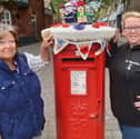 Allison Cusick (left) and Philippa Bell alongside their post box topper.