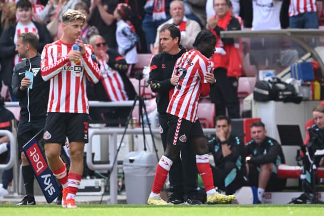 Sunderland player Eliezer Mayenda is congratulated by head coach Regis Le Bris after being substituted during the Sky Bet Championship match between Sunderland AFC and Sheffield Wednesday.