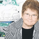 Sheila Graber against a background of children’s artwork.