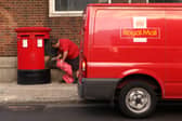 A Royal Mail employee empties a post box in London. Royal Mail has delayed its plans to scrap Saturday second-class letter deliveries until early 2026 (Photo: Oli Scarff/Getty Images)