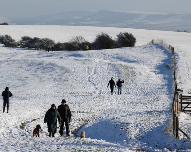 Walkers enjoy the snow at Ditchling Beacon in January 2025. Met Office snow and ice warnings are predicting dangerous travel conditions across the UK (Photo: Dan Kitwood/Getty Images)