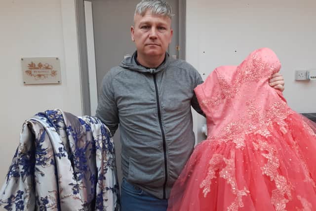 Lee Nicholson with some of the prom garments he loans out to disadvantaged families.