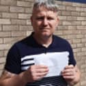 Building Blocks Day Centre CIC founder Lee Nicholson with the court notice claiming £25,000 over donated prom garments.