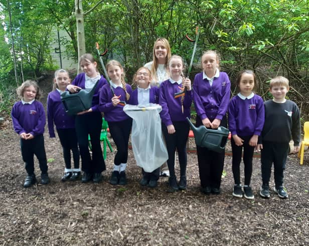 Teacher Courtney McCluskey working with children in the Forest School.