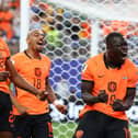 Brian Brobbey of the Netherlands celebrates with teammates Donyell Malen and  Denzel Dumfries.
