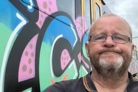 Museum founder and chair, David Charles, alongside the vandalised train.