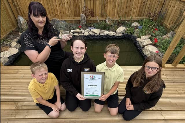 Fatfield Academy teacher and OPAL Lead Stacey Grotz with pupils Thea, Cohen, Mollie and Jake at the new school pond.