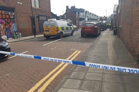 The police cordon on Cooperative Terrace as police officers carry out their investigations.