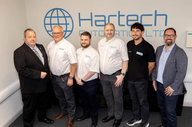 Cllr James Jackson (left) and Mark Hardy (right) with members of the Hartech Automation team.