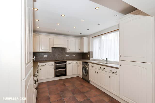 The large kitchen provides generous space for everyday cooking and family life within the home's traditional layout