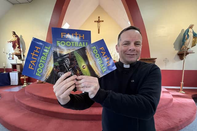 Father Marc Lyden-Smith with his new book, Faith and Football.
