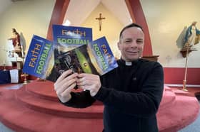 Father Marc Lyden-Smith with his new book, Faith and Football.