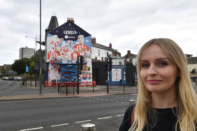 Artist Kathryn Robertson in front of her mural celebrating Sunderland AFC playing in Europe.