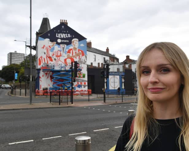 Artist Kathryn Robertson in front of her mural celebrating Sunderland AFC playing in Europe.