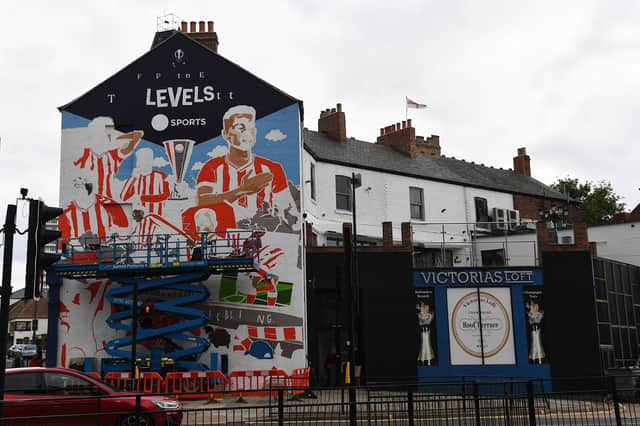 The 11 metre high mural beginning to take shape.