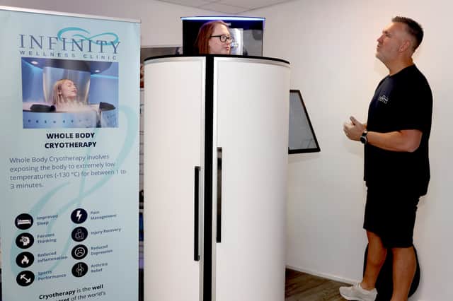Co-owner Steve McMullen demonstrating the Whole Body Cryotherapy.