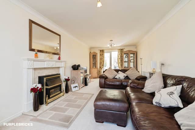 The spacious living room provides one of several substantial reception areas within the four-bedroom home